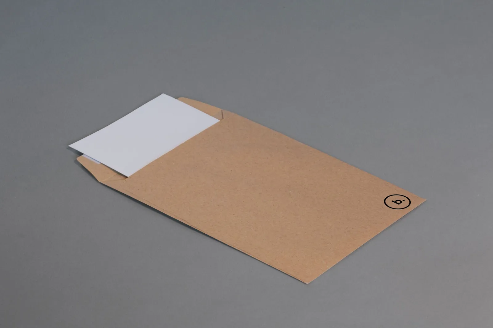 Brown kraft mailer, flat, on a grey background