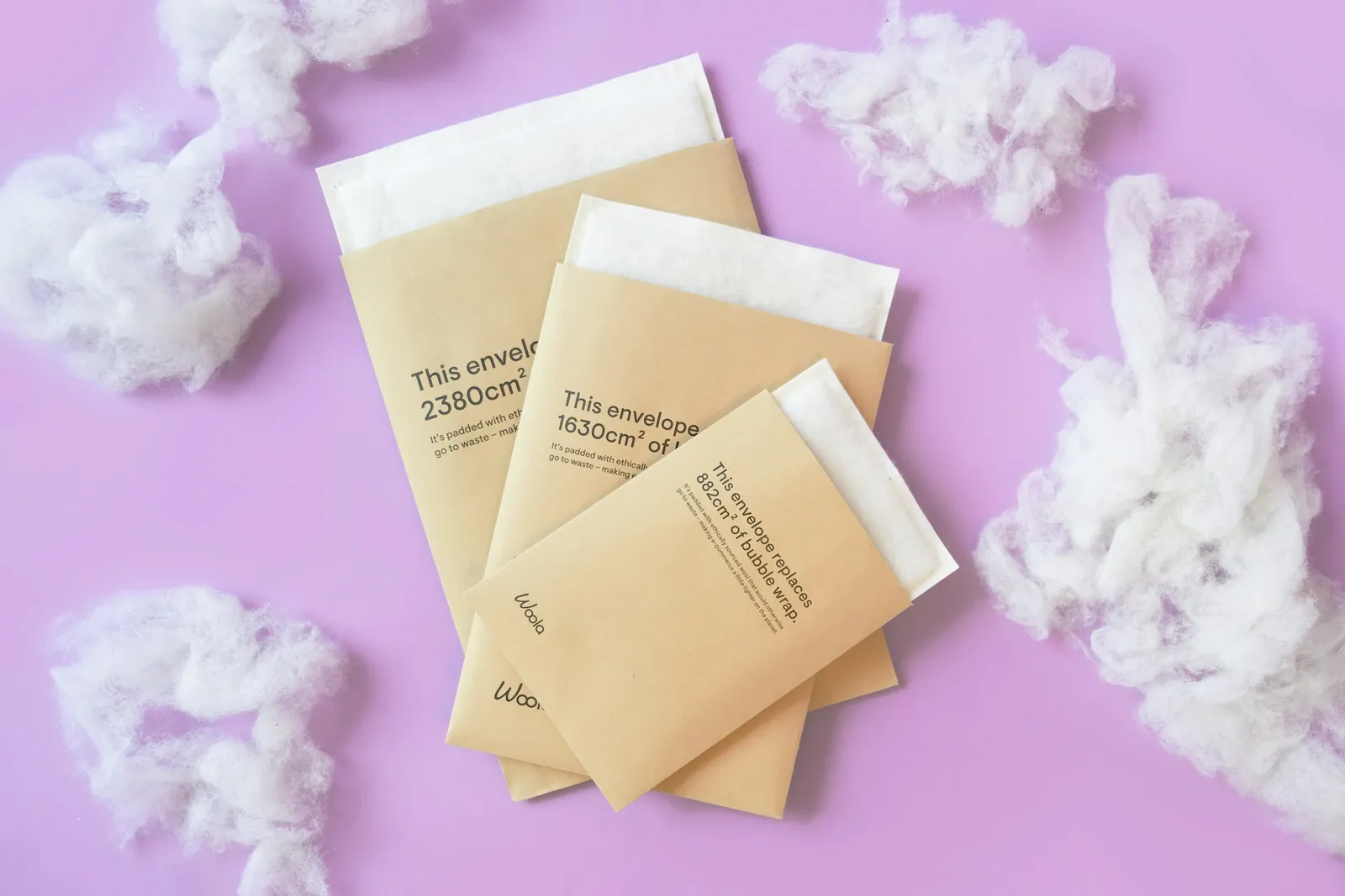 Three kraft padded mailers with white inserts